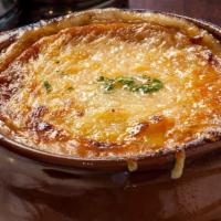 Onion Soup Gratin · cheese blend of mozzarella and Swiss cheese + garlic crouton topper