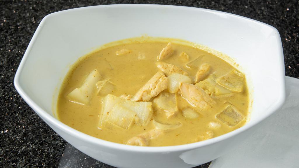 Yellow Curry (Curry Kai) · Tender slices of chicken simmered in coconut milk, a mild yellow curry paste, potatoes and onions.