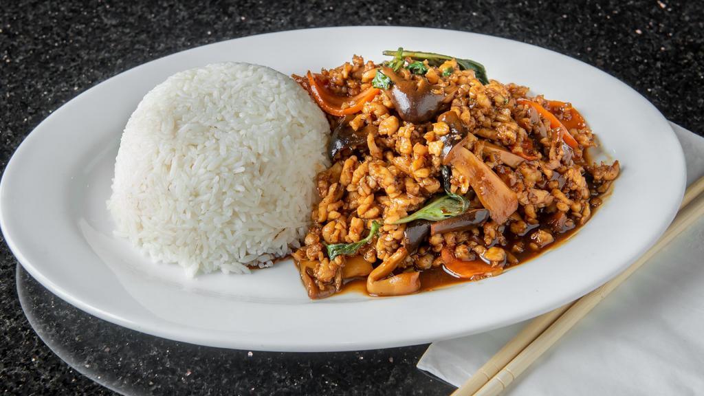 Spicy Basil Leaves With Ground Chicken · A famous dish in Thailand. This dish consists stir-fried ground chicken, straw mushrooms, carrots and Thai basil leaves in a homemade spicy sauce with steamed jasmine rice on the side.