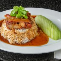 Bbq Pork Over Rice · Sliced Bbq pork in a tasty tangy brown sauce over steamed white rice with slices of fresh cu...