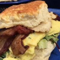 Egg, Cheese, Bacon Biscuit Sandwich · Classic Biscuit Man sandwich! Folded egg, American cheese and local bacon. On a buttermilk b...