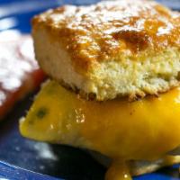 Egg And Cheese Biscuit · Folded egg and American cheese on a buttermilk biscuit.