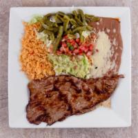 Steak Hacienda · Grilled ribeye steak served with rice, beans, guacamole salad, flour tortillas and our speci...
