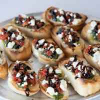 Torte Spread (Small) · Pesto and goat cheese topped with sun dried tomatoes served on 6 toasted bread planks topped...