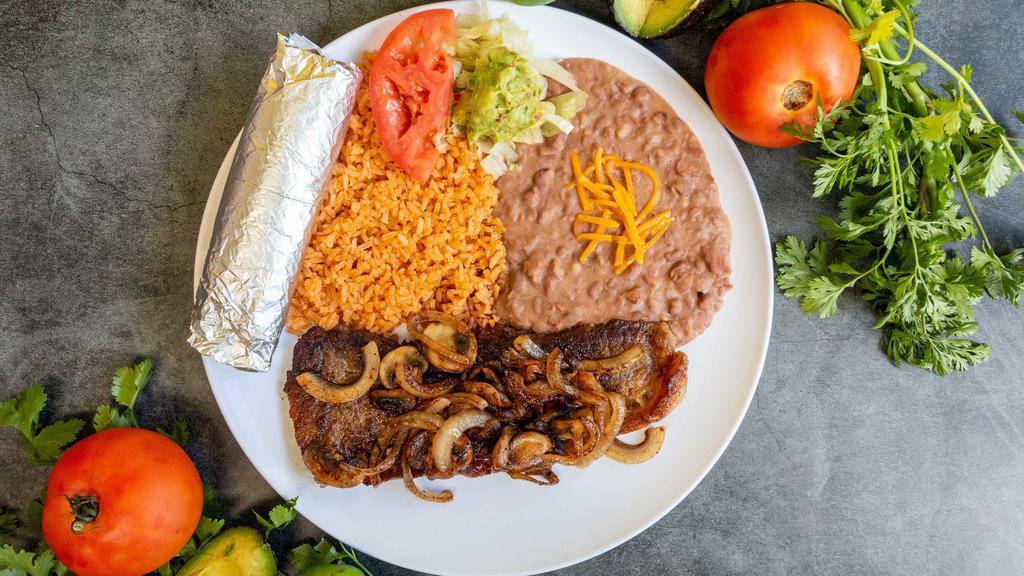 Bistec Tapatio / Steak Tapatio · ribeye steak  with rice beans salad guacamole and tortillas flour or corn.