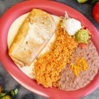 Chimichanga · chimichanga topped with cheese dip sauce with rice beans sour cream and guacamole.