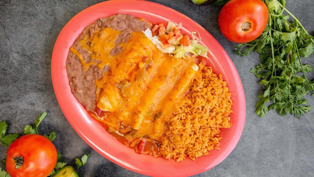 Enchiladas · three corn tortillas filed with your choice of meat topped with tomatoes base sauce melted cheese and on the side rice and beans.