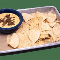 Cowboy Queso Appetizer · Our signature queso recipe served with. tortilla chips.