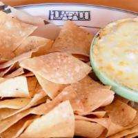 Spinach Artichoke Dip · Served with fresh fried corn chips.