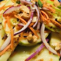 Apple Salad · Fresh sliced apples, cashews,red onions, roasted coconut, and tamarind dressing.