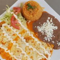 Enchiladas Suizas · Corn tortilla with your choice of meat stuffed with melted cheese in ranchera sauce