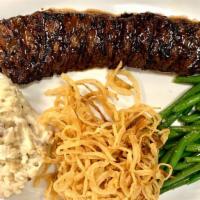 Skirt Steak · Marinated and wood-grilled. Served with homemade yukon gold mashed potatoes, sauteed vegetab...