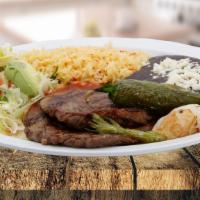 Grill Steak / Carne Asada · Served with rice, beans, salad, grill onion and jalapeño. / Servido con arroz, frijoles, ens...