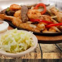 Fajitas · With onions and peppers. Served with lettuce, cheese and sour cream. / Con cebolla y pimient...