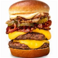 Signature Burger · Two patties of Midwest Angus Beef, American cheese , bacon, pickle, grilled onions, fried on...