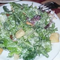 Caesar Salad · Fresh romaine lettuce tossed with garlic herb croutons, parmigiana cheese, and our own homem...