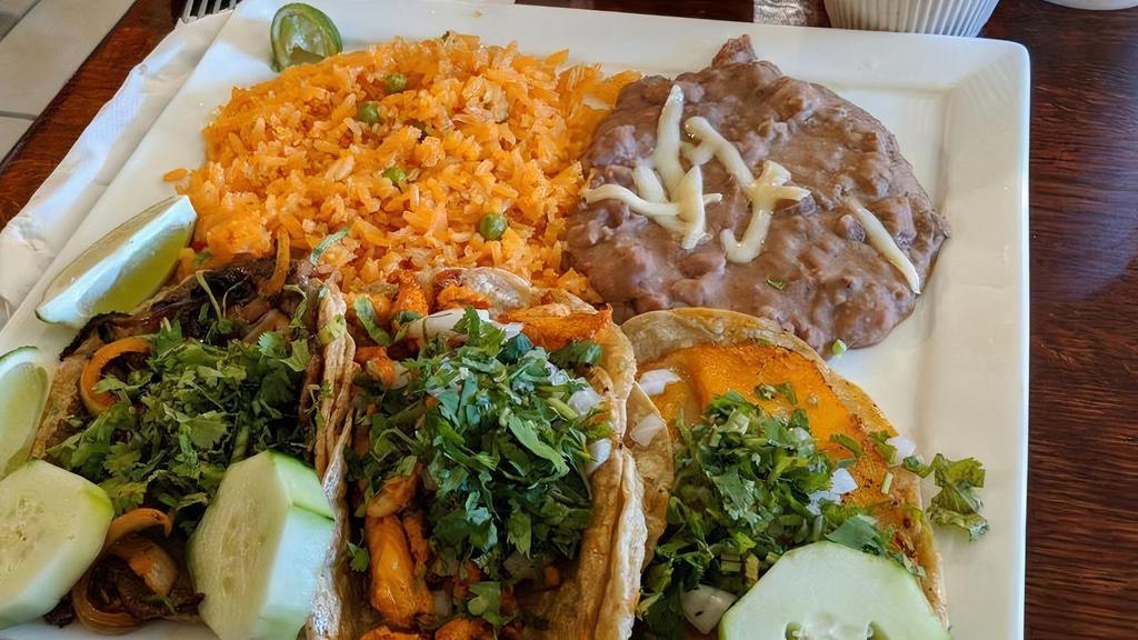 3 Tacos Dinner · Popular item. Choice of meat. Served with Mexican rice and beans. Topped with onion and cilantro.