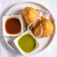 Samosa (2 Pcs) · Fried pastry dough filled with baked potato, mixed with onions, peas, lentils.
