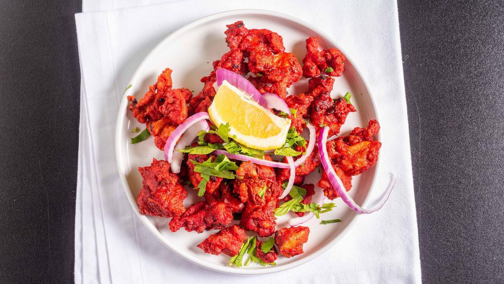Chicken 65 · Fried chicken tossed with green chilies, curry leaves and spices.