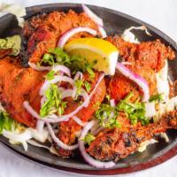 Tandoori Chicken · Chicken marinated overnight in yogurt with herbs and spices, cooked to perfection in clay ov...