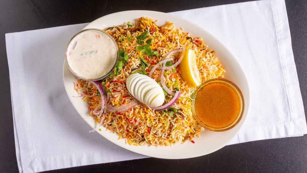 Indian Spice Spl Chicken Biryani · Basmati rice cooked with tender pieces of boneless chicken, blended with herbs and spice garnish with eggs, onions, and lemons.