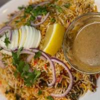Hydrabadi Chicken Dum Biryani · Basmati rice cooked with tender pieces of chicken, blended with herbs and spice garnish with...