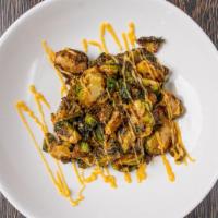 Crispy Brussels Sprouts · Crispy brussels sprout tossed in sweet chili & topped with siracha aioli and diced cashews.