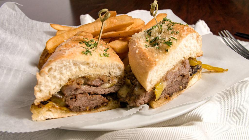 Philly Cheesesteak · Classic cheesesteak, mushroom, onion, banana peppers, mayo, mozzarella, and provolone cheese blend, hoagie bun.