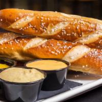 Soft Pretzel Dippers · Served with jalapeño aioli, and house-made queso sauce.