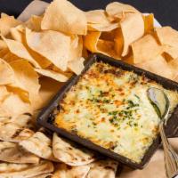 Spinach & Artichoke Dip · Vegetarian. Warm dip served with tortilla chips, grilled pitas, carrots, celery sticks.