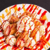 Fried Cheesecake · Fried raspberry filled cheesecakes, served with raspberry purée, caramel sauce, whipped cream.