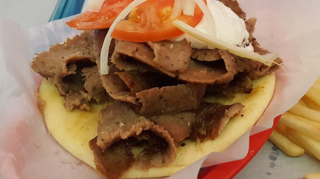 Gyros Sandwich · Delicious gyros cut fresh off the spit and served on a grilled pita with homemade gyro sauce (tzatziki) with onions and tomatoes.