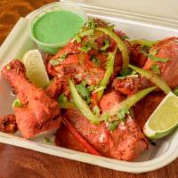 Tandoori Chicken · Chicken marinated in yogurt with ginger, garlic, Indian spices and roasted in clay oven.