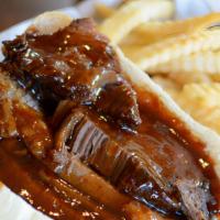 Beef Brisket Sandwich · Fresh sliced bbq beef brisket on French bread served with coleslaw or baked beans.