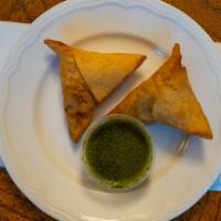 Samosa · Vegan. Two pieces. A classic fried pastry with a potato and pea filling.