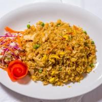 Thai Fried Rice · Steamed white rice stir-fried with sliced meat, egg, onion, peas, and carrots.