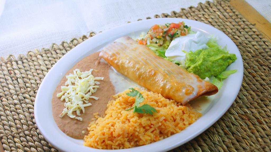 Chimichanga · A flour tortilla stuffed with chunks of beef, ground beef, or chicken, deep fried to a golden brown and topped with cheese dip, lettuce, sour cream, guacamole and pico de gallo. Served with rice and beans.