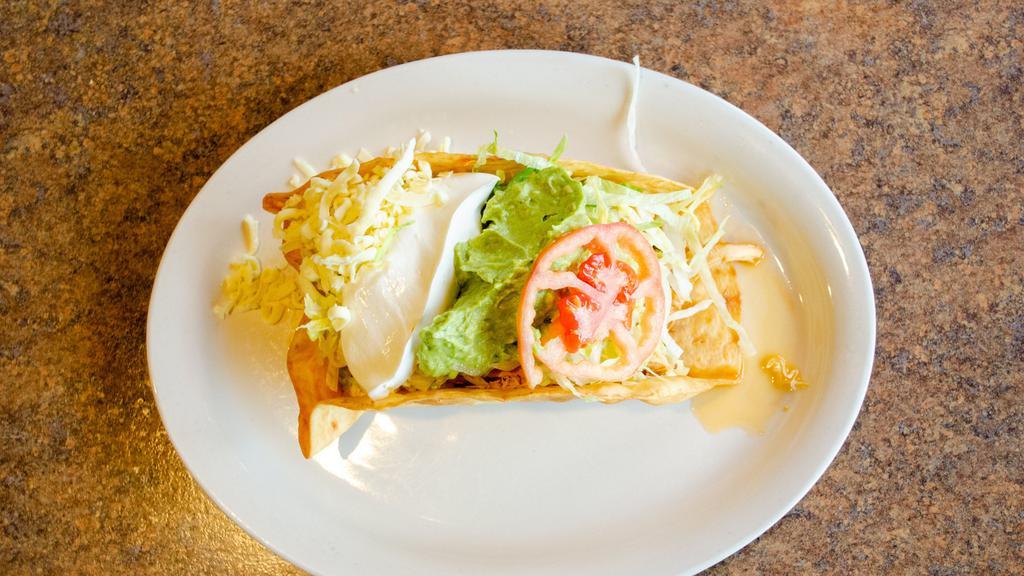 Taco Salad · A crispy flour tortilla filled with ground beef or shredded chicken topped with lettuce, tomato, sour cream, and cheese.