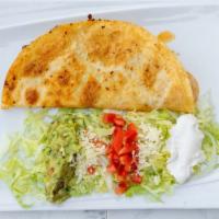 Fajita Quesadilla · Strips of fajita style beef or chicken with grilled onions and peppers in a quesadilla. Serv...