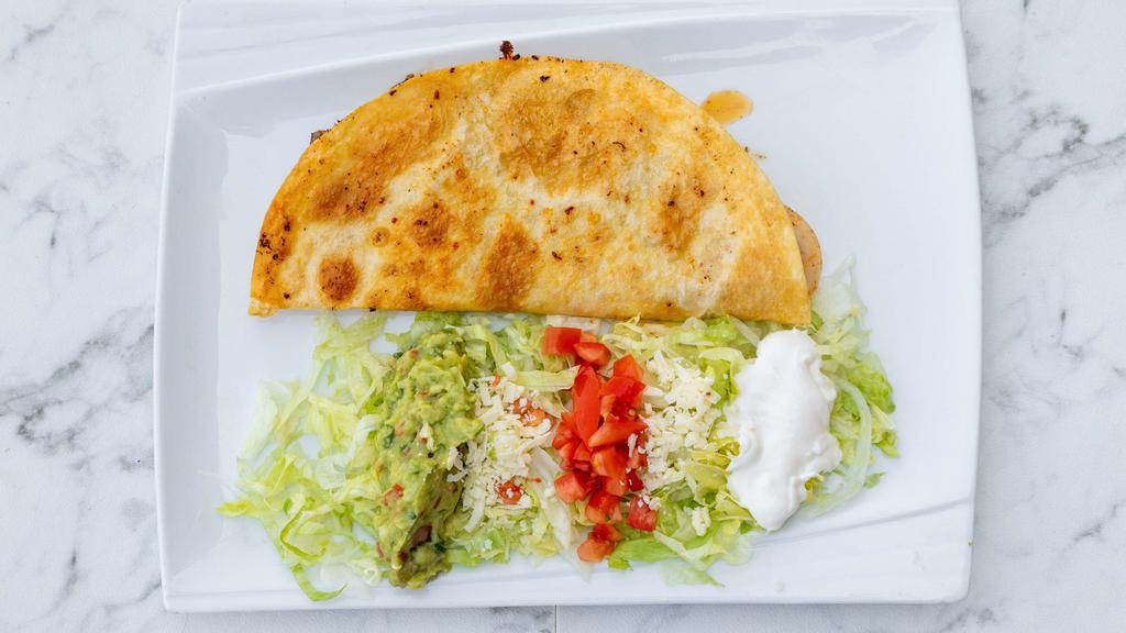 Fajita Quesadilla · Strips of fajita style beef or chicken with grilled onions and peppers in a quesadilla. Serve with guacamole salad.