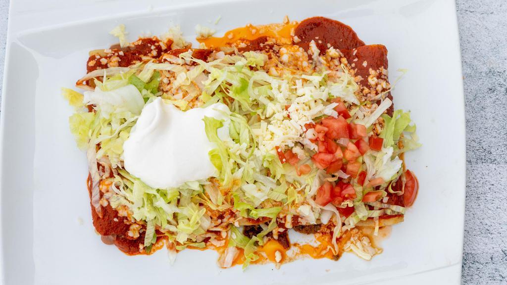 Enchiladas Super Rancheras · For the enchilada lover! Five different enchiladas: one beef, one chicken, one shredded beef, one bean and one cheese. Topped with cheese, lettuce, tomatoes, sour cream and special sauce.