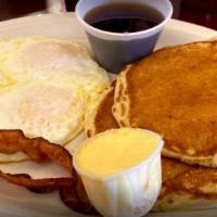 Cakes And Eggs · two eggs scrambled, 2 pancakes,  and your choice of 2 bacon or 2 sausage or ham