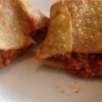 Pizza Puff · Fried and stuffed pizza pocket.