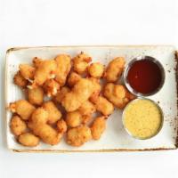 Wisconsin White Cheddar Cheese Curds · wisconsin white cheddar / lightly breaded / fried crispy / house beer mustard / hot honey