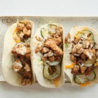 Hot Nash Tacos · grilled chicken / nashville hot seasoning / lettuce / chopped pickles / cheddar / pickled re...