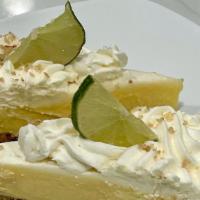 Key Lime Pie · Key lime custard baked in a graham cracker crust. Topped with whipped cream.