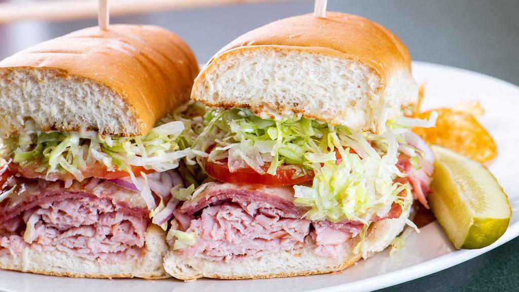 Assorted Hoagie · Ham and salami on a garlic toasted white or wheat hoagie bun. Topped with lettuce, tomato, onions, mayo, and our red wine vinaigrette dressing