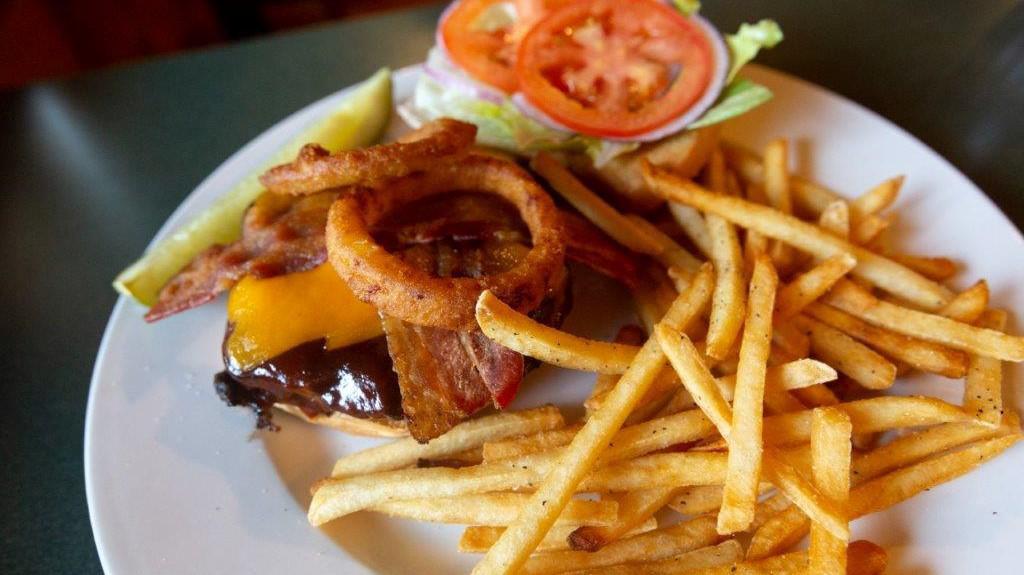 Western  · 1/2 pound burger or 6oz chicken breast on a brioche bun with cheddar cheese, BBQ sauce, bacon, onion rings. Topped with Lettuce, tomato, onion