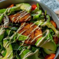 Salmon Cake Salad · Mixed greens, cherry tomatoes, red onions, cucumbers, avocado, house vinaigrette, and graine...