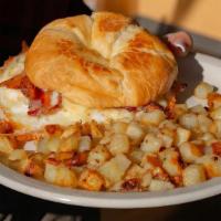 Croissant Sandwich · Grilled croissant sandwich filled with two scrambled eggs, white cheddar cheese and Virginia...